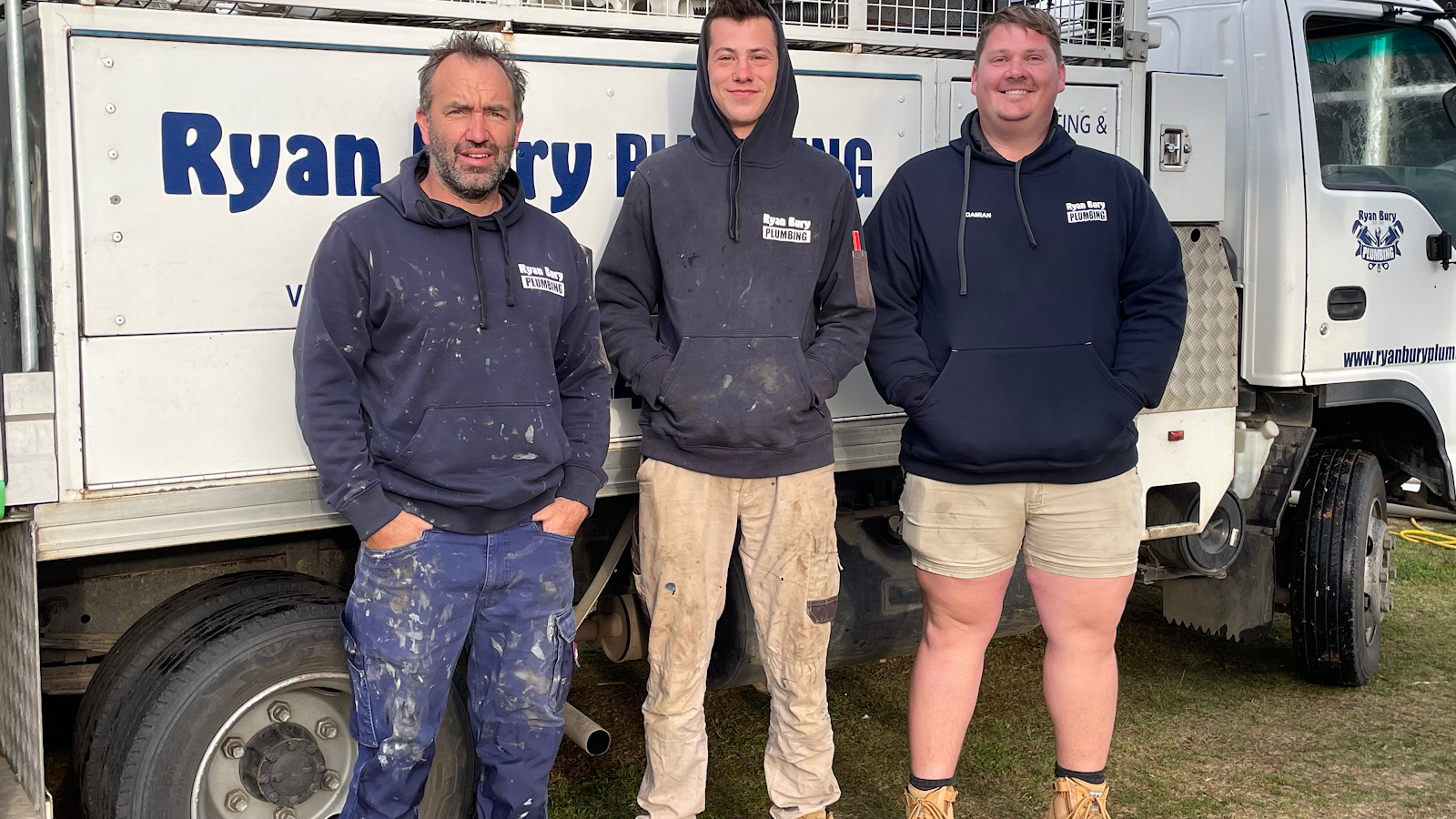 The Ryan Bury Plumbing crew standing in front of their work truck